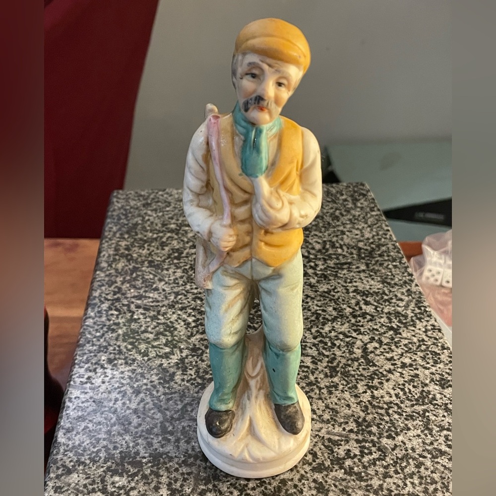 Vintage figurine of an old man hunting